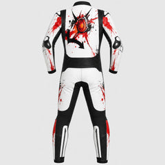 A full-body white and black racing suit shown from the back, featuring a large red and black graphic on the upper back and red paint-splatter accents on the arms and legs, set against a solid light gray background.