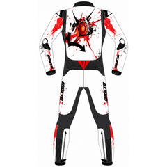 A full-body rear view of a one-piece racing suit or jumpsuit shown on a plain white background. The suit is primarily white with black panels and graphic details, including a large red and black back print resembling a stylized eye or skull motif, plus red splatter graphics on the shoulders and upper legs.