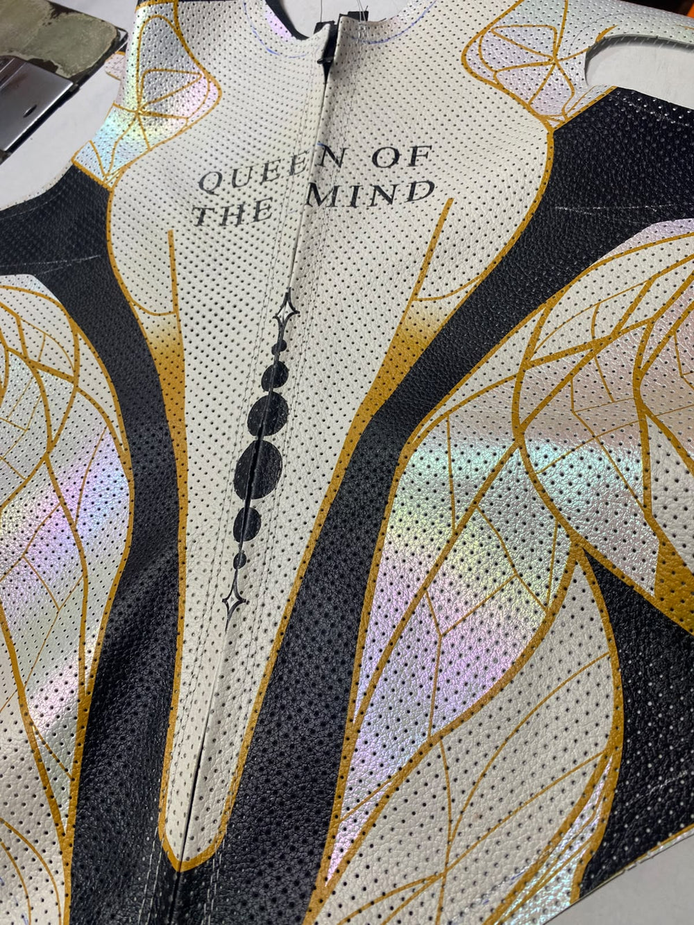 perforated kangaroo leather and iridescent gold-patterned panels on a women’s bespoke motorcycle suit