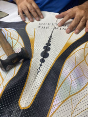 Craftsperson aligning personalized leather panels for a women’s made-to-order 1-piece motorcycle suit