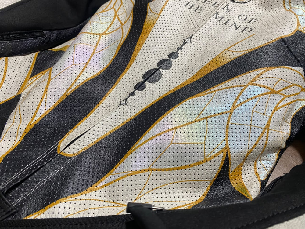 Personalized Queen of the Mind lettering on the perforated chest of a women’s 1-piece kangaroo leather suit