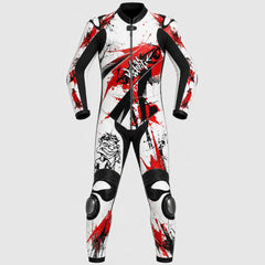 A full-body one-piece wetsuit or racing suit with a white base, black sleeves, collar, and trim, plus bold red paint-splatter graphics and black graphic artwork on the front, shown on a light gray background.