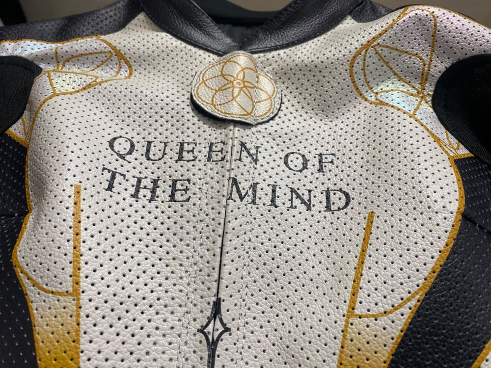 Gold linework and iridescent panels on a women’s custom one-piece kangaroo leather motorbike suit